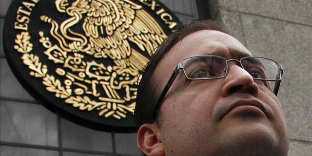 FILE - In this Aug. 5, 2016, file photo, Veracruz Gov. Javier Duarte stands outside the Attorney General's headquarters in Mexico City. The Institutional Revolutionary Party’s national justice committee said in a statement Monday, Sept. 26, that it removed the party rights of Veracruz Gov. Duarte and six other party members. Duarte is under federal investigation for corruption. (AP Photo/Marco Ugarte,File)