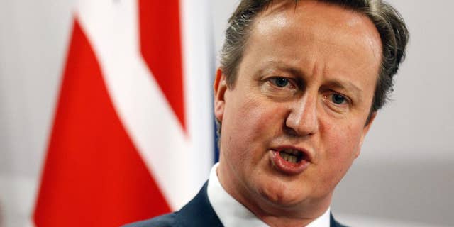 FILE - This is a Friday, May 22, 2015 file photo of British Prime Minister David Cameron as he speaks during a media conference at the conclusion of the Eastern Partnership summit in Riga, Latvia. Cameron declared Sunday July 19, 2015 that Britain needs to take a greater role in destroying the Islamic State group in Syria, his most direct signal to date that he will seek to expand his country's role in supporting the United States and its allies. (AP Photo/Mindaugas Kulbis, File)