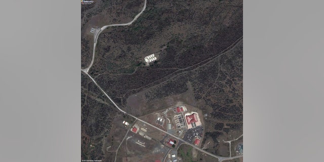 This satellite image provided by TerraServer.com and DigitalGlobe shows an image captured on Sept. 2, 2010, shows a portion of Naval Station Guantanamo Bay, Cuba, including the secret facility known as Penny Lane, upper middle in white. In the early years after 9/11, the CIA turned a handful of prisoners at the secret facility into double agents and released them. Current and former U.S. officials tell The Associated Press that the program helped kill terrorists. The program was carried out in the secret facility, built a few hundred yards from the administrative offices of the prison in Guantanamo Bay, bottom of image. The eight small cottages were hidden behind a ridge covered in thick scrub and cactus. (AP Photo/TerraServer.com and DigitalGlobe)