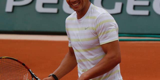 Defending champion Spain's Rafael Nadal smiles during a training session for the French Open tennis tournament, at the Roland Garros stadium in Paris, Friday, May 23, 2014. The French Open tennis championship will start Sunday. (AP Photo/Bertrand Combaldieu)