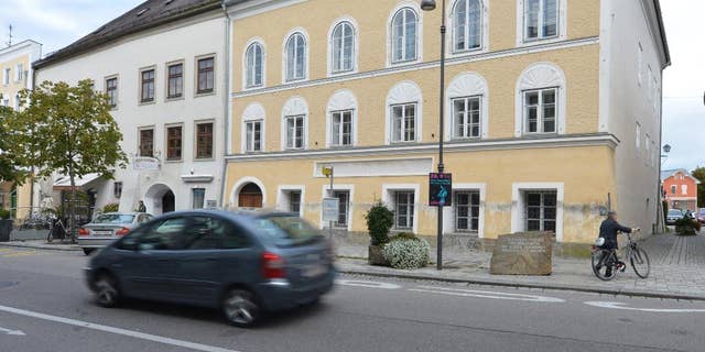 FILE - This Sept. 27, 2012 file picture shows an exterior view of Adolf Hitler's birth house , front, in Braunau am Inn, Austria.   Austria’s Interior Ministry says the government has drawn up a draft law that would dispossess the owner of the house where Adolf Hitler was born. Tuesday’s July 12, 2016  move follows steadfast refusal by house owner Gerlinde Pommer to sell the empty building in the town of Braunau am Inn on the German border. The government has sought ownership so it can take measures to lessen its attraction as a shrine for the Nazi dictator’s admirers.  (AP Photo / Kerstin Joensson,file)