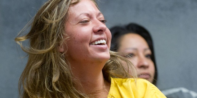 Aug. 11: Lee Grace Dougherty, 29, laughs at the Pueblo County Sherrif's Office detention center.