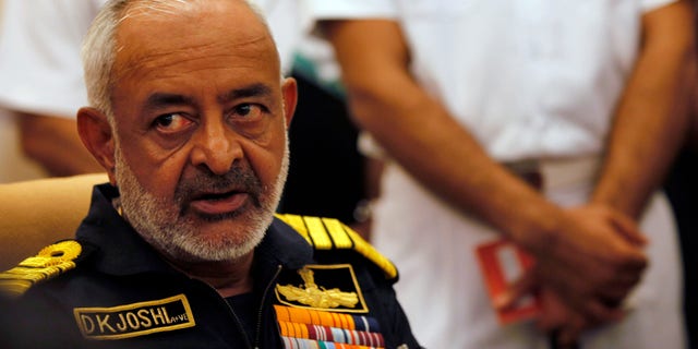 FILE - In this Wednesday, Aug. 14, 2013 file photo, India's navy chief Admiral D.K. Joshi watches at a press conference in Mumbai, India. Joshi resigned Wednesday hours after seven sailors were overcome with smoke on an Indian navy submarine, and two other sailors were missing in an accident off Mumbai’s coast. (AP Photo/Rajanish Kakade, File)