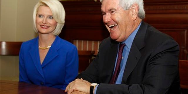 March. 3: Former House Speaker Newt Gingrich, R-Ga., speaks as his wife Callista looks on during a meeting with Gov. Nathan Deal in the Governor's office in Atlanta. Fox News contributors Newt Gingrich and Rick Santorum have been put on leave from the cable news channel for 60 days, as the two contemplate whether they will run for the 2012 Republican presidential nomination.
