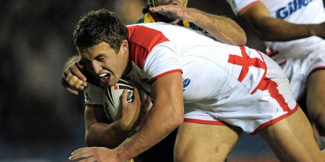 England's Sam Burgess (left) evades a tackle from Australia's Johnathan Thurston during a rugby league international at Elland Road, northern England, on November 14, 2009