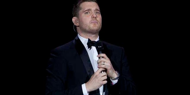 FILE - In this Jan. 31, 2014, file photo, Canadian singer Michael Buble performs during his concert at Palacio de los Deportes in Madrid, Spain. Buble announced on Nov. 4, 2016, that his 3-year-old son has been diagnosed with cancer and is undergoing treatment in the U.S. (AP Photo/Abraham Caro Marin, File)