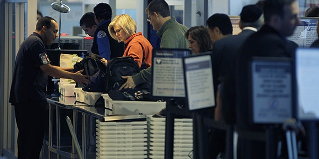 Nov. 23: Travelers make their way through a security checkpoint at LaGuardia Airport in New York.