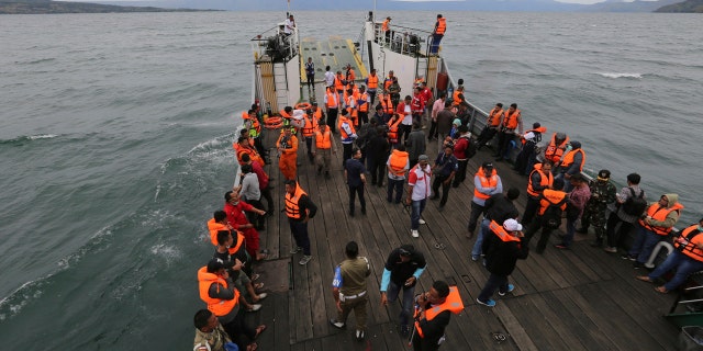An Indonesia search and rescue team searches for a ferry which sank Monday in lake Toba, North Sumatra, Indonesia, Tuesday, June 19, 2018.
