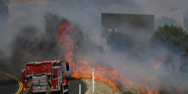 Flames approaching a fire truck near Lake Isabella, Calif. on Friday.
