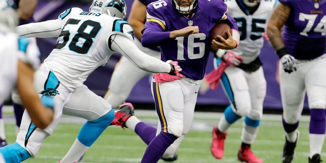 Carolina Panthers outside linebacker Thomas Davis, left, chases down Minnesota Vikings quarterback Matt Cassel (16) as he runs during the first half of an NFL football game in Minneapolis, Sunday, Oct. 13, 2013. (AP Photo/Ann Heisenfelt)