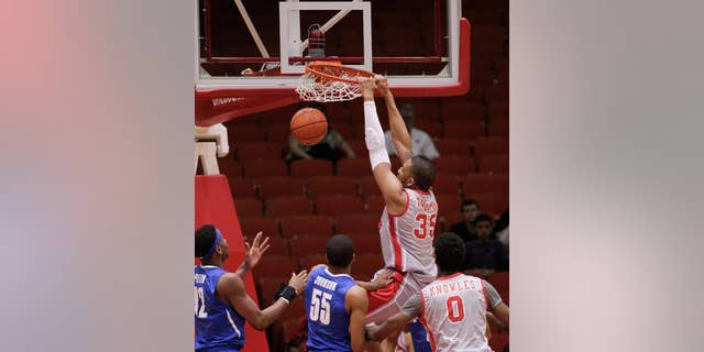 Houston's forward TaShawn Thomas (35) dunks on Memphis' Geron Johnson (55) during the first half of an NCAA college basketball game, Thursday, Feb. 27, 2014, in Houston. (AP Photo/Bob Levey)