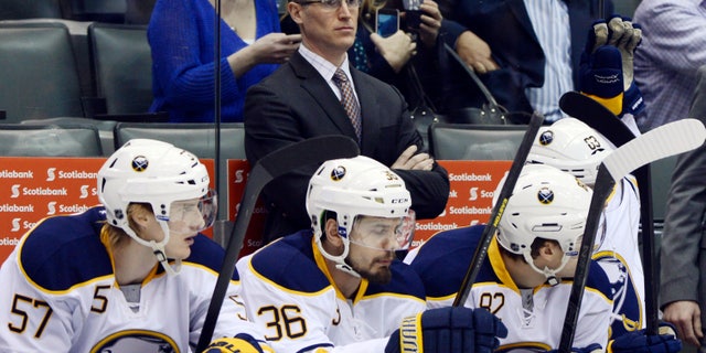 Buffalo Sabres interim head coach Ron Rolston stands behinds his players during an NHL hockey game against the Toronto Maple Leafs in Toronto, Thursday, Feb. 21, 2013. The Sabres fired head coach Lindy Ruff on Wednesday. (AP Photo/The Canadian Press, Frank Gunn)