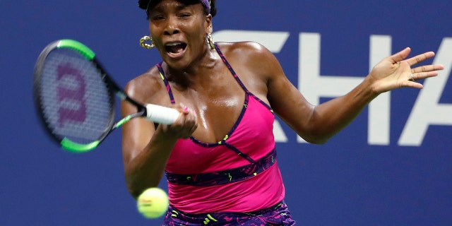 Venus Williams returns a shot to Serena Williams during the third round of the U.S. Open tennis tournament, in Flushing, N.Y., Aug. 31, 2018.
