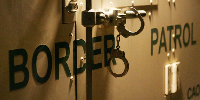 YUMA, AZ - MARCH 17: Handcuffs secure the back door of a US Customs and Border Protection border patrol vehicle loaded with suspected illegal immigrants on the California side of the Colorado River on March 17, 2006 near Yuma, Arizona. As Congress begins a new battle over immigration policy, U.S. Customs and Border Protection (CBP) border patrol agents in Arizona are struggling to control undocumented immigrants that were pushed into the region by the 1990?s border crack-down in California called Operation Gatekeeper. A recent study by the Pew Hispanic Center using Census Bureau data estimates that the U.S. currently has an illegal immigrant population of 11.5 million to 12 million, about one-third of them arriving within the past 10 years. More than half are from Mexico. Beefed-up border patrols and increased security are reportedly having the unintended result of deterring many from returning to their country of origin. (Photo by David McNew/Getty Images)