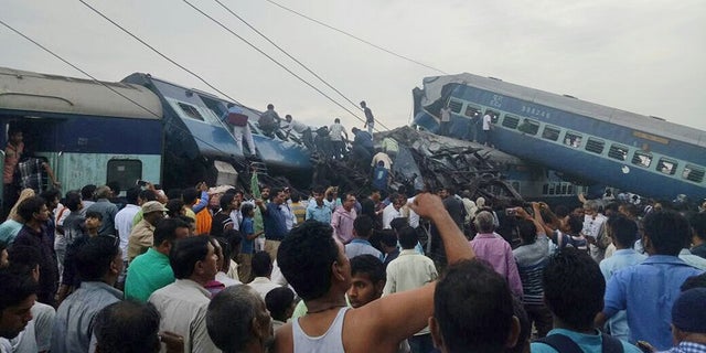 Railway police and local volunteers look for survivors in the upturned coaches of the Kalinga-Utkal Express after an accident near Khatauli, in the northern Indian state of Uttar Pradesh, Saturday, Aug. 19, 2017. Six coaches of a passenger train derailed in northern India on Saturday, killing more than 20 people and injuring dozens, officials said. (AP Photo)