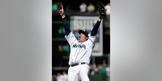 FILE - In this Aug. 15, 2012, file photo, Seattle Mariners pitcher Felix Hernandez reacts after throwing a perfect game against the Tampa Bay Rays in Seattle. Hernandez and the Mariners are working on a $175 million, seven-year contract that would make him the highest-paid pitcher in baseball, according to a person with knowledge of the deal's details. The person spoke to The Associated Press Thursday, Feb. 7, 2013, on condition of anonymity because the agreement has not been completed. (AP Photo/Ted S. Warren, File)