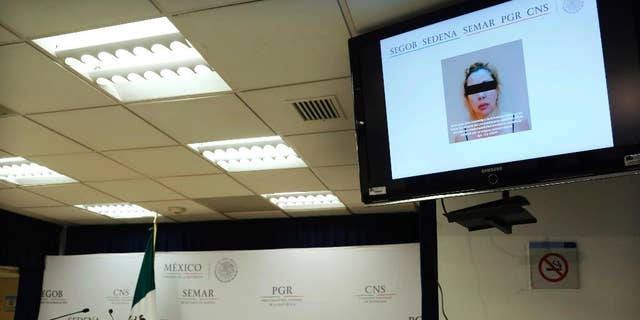 A woman identified by authorities as Clara Laborin Archuleta, wife of jailed drug lord Hector Beltran Leyva, is shown on a monitor during a news conference by federal police in Mexico City, Tuesday, Sept. 13, 2016. Federal police say Archuleta was arrested on Monday in the northern state of Sonora. She's alleged to have been involved in efforts to reassert her husband’s gang’s control over criminal operations in the Pacific coast resort city of Acapulco. (AP Photo/Marco Ugarte)