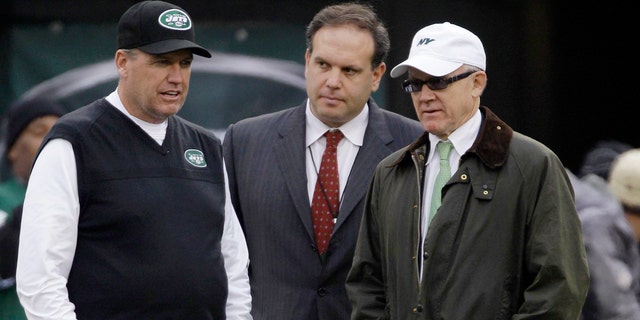FILE - In this Dec. 2, 2012, file photo, New York Jets head coach Rex Ryan, left, stands with general manager Mike Tannenbaum, center, and owner Woody Johnson before an NFL football game against the Arizona Cardinals in East Rutherford, N.J. Ryan insists he's a Jet all the way and wants to coach the team for the "next 15 years." He dismisses as "untrue" a report that says he would welcome being fired if Johnson doesn't upgrade the offense. (AP Photo/Kathy Willens, File)