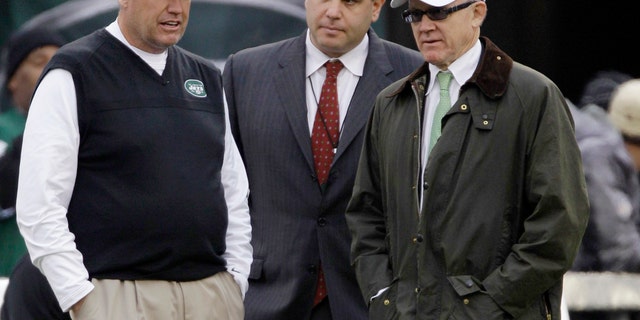 FILE - In this Dec. 2, 2012, file photo, New York Jets head coach Rex Ryan, left, stands with general manager Mike Tannenbaum, center, and owner Woody Johnson before an NFL football game against the Arizona Cardinals in East Rutherford, N.J. Ryan insists he's a Jet all the way and wants to coach the team for the "next 15 years." He dismisses as "untrue" a report that says he would welcome being fired if Johnson doesn't upgrade the offense. (AP Photo/Kathy Willens, File)