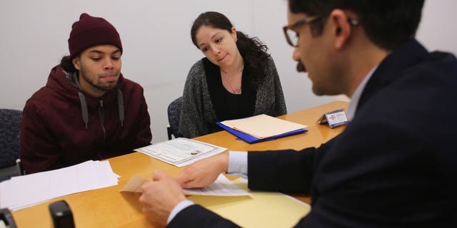 NEW YORK, NY - JANUARY 31: Immigration lawyer Andres Lemons advises Angel and Evie Gomez on their U.S. citizenship application on January 31, 2013 in New York City. The married couple, he from the Dominican Republic, and she from Canada are soon to have a baby and are working through the long process to become U.S. citizens. Lemons works at the CUNY Citizenship Now "Express Center" in New York's Washington Heights. The non-profit helps some 8,000 immigrants in the New York area navigate through the complicated process of acquiring U.S. Citizenship and provides free legal information for the immigrant community. (Photo by John Moore/Getty Images)