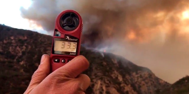 In this image from video provided by the Santa Barbara County Fire Department, a wind speed indicator held by a U.S. Forest Service fire fighter on Gibraltar Road at the W. Fork of Cold Spring Trail, shows just how fast and varied the speed of the wind is blowing down canyon. In this video it varied from 10-33 mph in Santa Barbara, Calif., Saturday, Dec. 16, 2017.