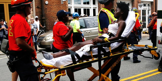 Rescue workers transporting a victim who was injured Saturday when a car drove through a group of counter-protesters in Charlottesville.