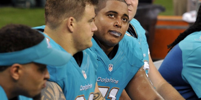 FILE - In this Sept. 30, 2013 file photo, Miami Dolphins guard Richie Incognito (68), center left, and and tackle Jonathan Martin (71), center right, sit on the bench in the second half of an NFL football game against the New Orleans Saints in New Orleans. About halfway between the start of exhibition games and the Super Bowl, there have been plenty of unwanted story lines. Bullying in the locker room, coaches collapsing, serious injuries to marquee players, the D.C. Council's call on Washington's pro football team to change its name _ examples from the past week alone. (AP Photo/Bill Feig, File)
