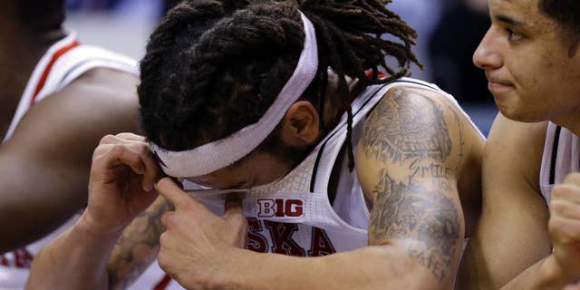 Nebraska forward Terran Petteway wipes his face on the bench in the second half of an NCAA college basketball game against Ohio State in the quarterfinals of the Big Ten Conference tournament Friday, March 14, 2014, in Indianapolis. Ohio State won 71-67. (AP Photo/Michael Conroy)