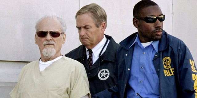 Tony Alamo, left, is escorted from the Federal Court House in Texarkana, Ark., on July 23, 2009. His infamous case is the subject of a new special titled “People Magazine Investigates: Cults" on Investigation Discovery.