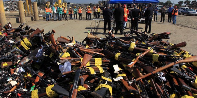 July 30, 2013: Guns to be melted lie in a pile near a news conference at the Los Angeles County Sheriff's Department's 20th annual Gun Melt at the Gerdau Steel Mill in Rancho Cucamonga, California.