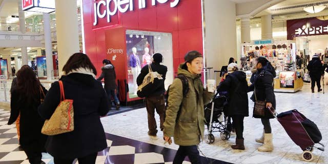 In this Feb. 19, 2015 photo, shoppers visit a J.C. Penney store, in New York. The Texas-based retailer reports quarterly financial results after the market closes Thursday, Feb. 26, 2015. (AP Photo/Mark Lennihan)