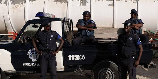 Angolan police officers stand guard in Luanda on January 16, 2010