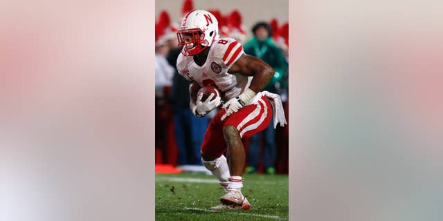 Nebraska's Ameer Abdullah runs for a 2-yard touchdown during the fourth quarter of an NCAA college football game against Michigan State, Saturday, Oct. 4, 2014, in East Lansing, Mich. Michigan State won 27-22. (AP Photo/Al Goldis)