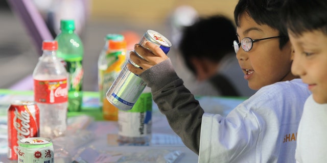 SAN FRANCISCO - NOVEMBER 12: A student at Fairmount Elementary School looks at a display showing how much sugar is in soft drinks and juices on November 12, 2010 in San Francisco, California. (Photo by Justin Sullivan/Getty Images)