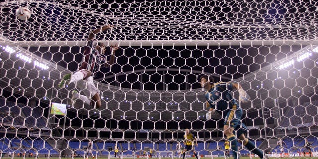 Brazil's Fluminense goalkeeper Ricardo Berna, right, and Digao, left, fail to stop a goal by Vicente Sanchez of Mexico's CF America during a Copa Libertadores soccer match in Rio de Janeiro, Brazil, Wednesday, March 23, 2011. Brazil's Fluminense won the match 3-2. (AP Photo/Felipe Dana)