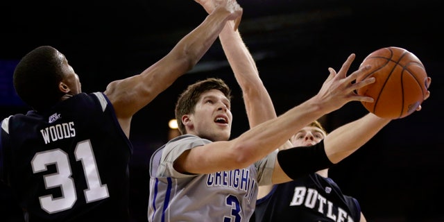 Creighton's Doug McDermott (3) goes for a layup against Butler's Kameron Woods (31) and Erik Fromm (4) in the second half of an NCAA college basketball game in Omaha, Neb., Tuesday, Jan. 14, 2014. Creighton won 88-60. (AP Photo/Nati Harnik)