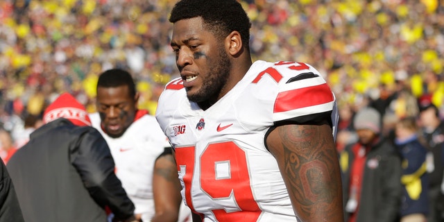 Ohio State offensive linesman Marcus Hall (79) walks the sidelines after being ejected from the game during the second quarter of an NCAA college football game against Michigan in Ann Arbor, Mich., Saturday, Nov. 30, 2013. The third-ranked Buckeyes lost Hall and kick returner Dontre Wilson and the Wolverines lost backup linebacker Royce Jenkins-Stone to ejections. All three players were flagged for unsportsmanlike conduct and had to leave the field after a skirmish. (AP Photo/Carlos Osorio)
