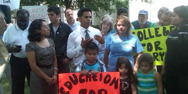 Erick Velazquillo, center wearing a tie, responds to a decision following a Charlotte, N.C., deportation hearing.