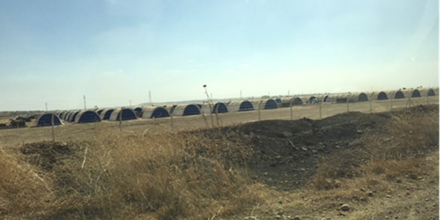 A camp of steel huts waits on the outskirts of Mosul, where a flood of refugees is expected to stream out of the city when the expected assault begins.