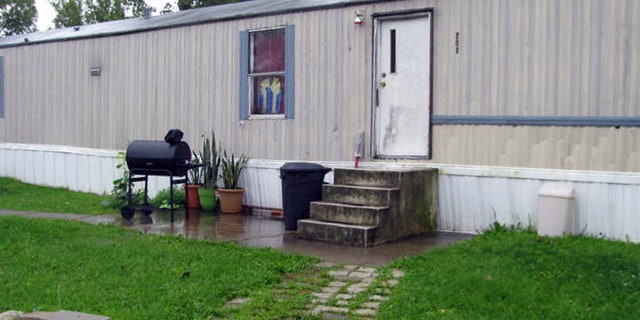 This photo taken July 17, 2015 shows a mobile home that prosecutors say Guatemalan teenagers were forced to live in when they weren’t working at egg farms in Marion, Ohio. Prosecutors say immigrant teenagers brought to Ohio and forced to work long hours on egg farms had been fraudulently plucked from U.S. custody after arriving at the border. (AP Photo/Mitch Stacy)