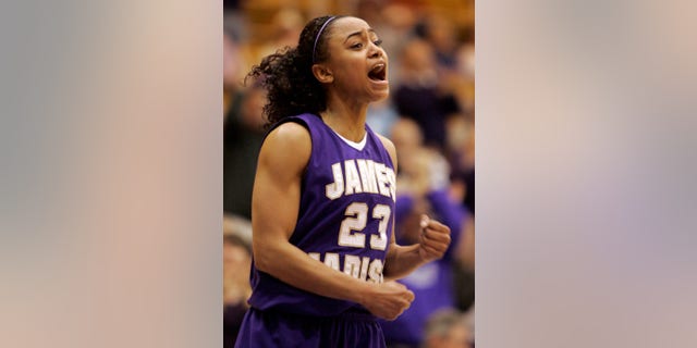 FILE - In this March 14, 2009, file photo, James Madison guard Dawn Evans rallies her team during second half of an NCAA college basketball game in Harrisonburg, Va. Evans, one of the nation's leading scorers for three years as a point guard at James Madison, has left her professional team in France and returned to Tennessee to prepare for a kidney transplant. (AP Photo/Steve Helber, File)