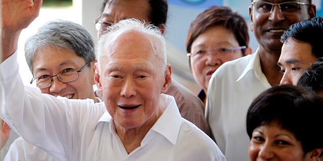 FILE - In this April 27, 2011 file photo, Singapore's Minister Mentor Lee Kuan Yew waves to supporters as he arrives at an elections nomination center in Singapore. A statement from the Prime Minister's Office says the 89-year-old Lee was admitted to Singapore General Hospital on Friday, FEB. 15, 2013, after experiencing a suspected transient ischaemic attack, which occurs when blood flow to the brain stops for a period of time. The condition is associated with irregular heartbeats. (AP Photo/Wong Maye-E, File)