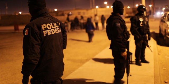 JUAREZ, MEXICO - MARCH 21: Mexican police investigate a violent incident on March 21, 2010 in Juarez, Mexico. The border city of Juarez has been racked by violent drug related crime recently and has quickly become one of the most dangerous cities in the world. As drug cartels have been fighting over ever lucrative drug corridors along the United States border, the murder rate in Juarez has risen to 173 slayings for every 100,000 residents. President Felipe Calderon in 2009 disbanded the corrupt local police force and sent 10,000 soldiers to Juarez, but the violence has raged on. With a population of 1.3 million in Juarez, 2,600 died in drug-related violence last year and 500 so far this year, including two Americans who worked for the U.S. Consulate last weekend as they returned from a children's party. (Photo by Spencer Platt/Getty Images)