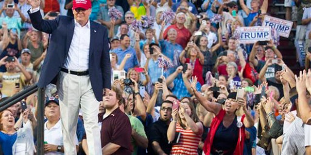 Aug 21., 2015: Republican presidential candidate Donald Trump waves to supporters during a campaign rally in Mobile, Ala.