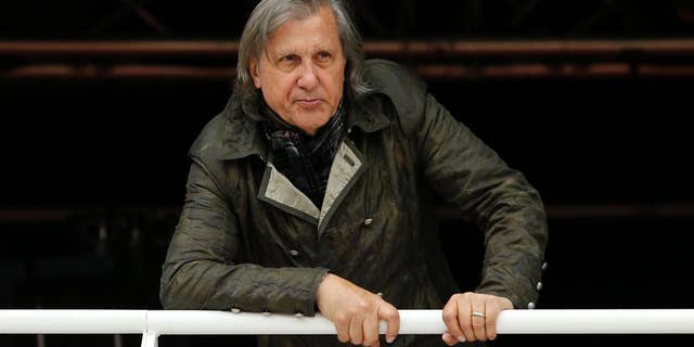 FILE - In this Monday, May 23, 2016 file picture, former Romanian tennis ace Ilie Nastase watches a match of the French Open tennis tournament at the Roland Garros stadium, in Paris, France. Ilie Nastase has received Romania's highest award, the Star of Romania, on his 70th birthday from President Klaus Iohannis for services to sport in Bucharest, Romania, Tuesday, July 19, 2016. (AP Photo/Alastair Grant, File)
