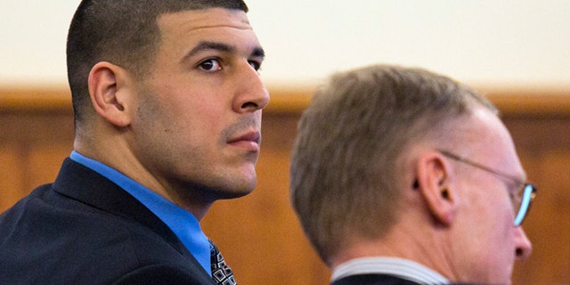 March 11, 2015: Former New England Patriots football player Aaron Hernandez, left, looks back as he sits with his defense attorney Charles Rankin during his murder trial at Bristol County Superior Court.