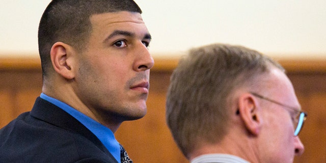 March 11, 2015: Former New England Patriots football player Aaron Hernandez, left, looks back as he sits with his defense attorney Charles Rankin during his murder trial at Bristol County Superior Court.