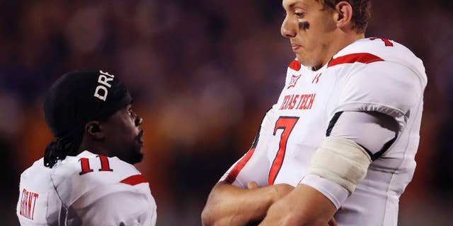 Texas Tech quarterback Davis Webb (7) talks with wide receiver Jakeem Grant (11) during a play review in the second half of an NCAA college football game against Kansas State in Manhattan, Kan., Saturday, Oct. 4, 2014. (AP Photo/Orlin Wagner)