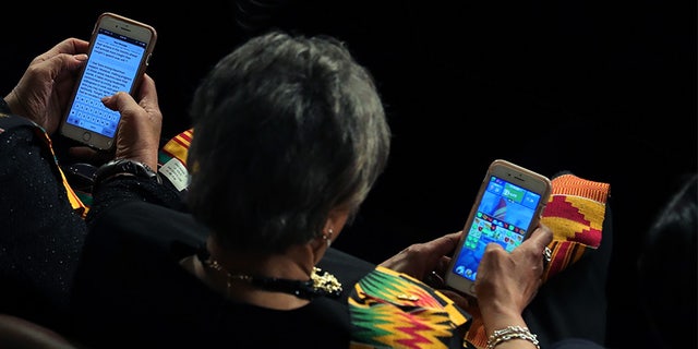 Members of Congress look at their cell phones during the State of the Union address.