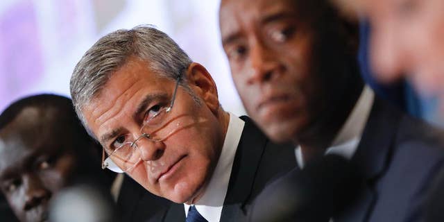 Actors George Clooney, left center, and Don Cheadle, right, during a press conference to discuss an investigation about corruption in South Sudan at the National Press Club in Washington, in 2016.